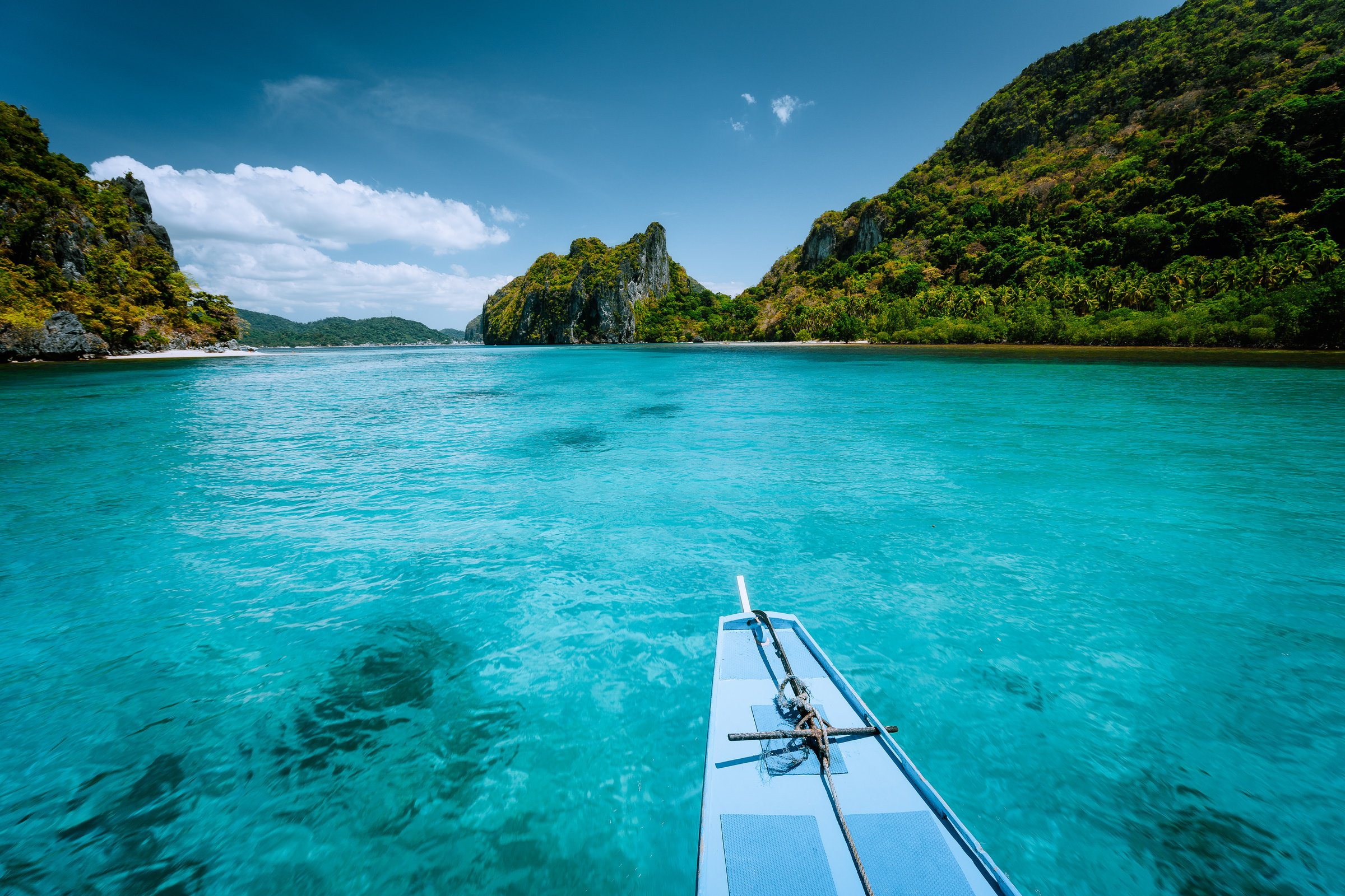 Boat trip to tropical islands El Nido, Palawan, Philippines. Steep green mountains and blue water lagoon. Discover exploring unique nature, journey to paradise